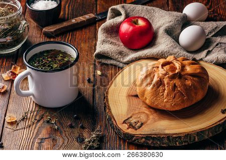 Rustic Breakfast With Traditional Tatar Pastry Elesh, Herbal Tea In Metal Mug, Apple And Boiled Eggs