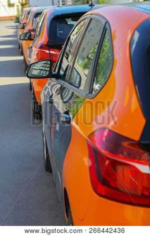 MOSCOW - MAY 8, 2018: Back of five black and orange BMW cars are on street for carsharing, Moscow carsharing company You drive
