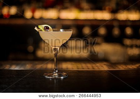 Daiquiri Cocktail Decorated With Lime Slice And Berry Standing On The Bar Counter On The Blurred Bac