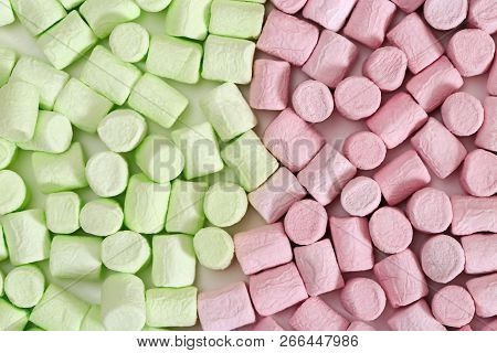 Background From Bright Green And Pink Mini Marshmallow. Sweet Zephyr. Fon From Marshmallows Close Up