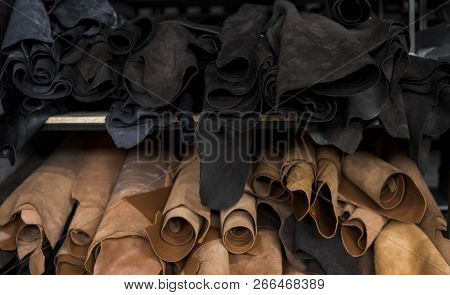 Different Pieces Of Leather In A Rolls. The Pieces Of The Colored Leathers. Rolls Of Natural Brown A