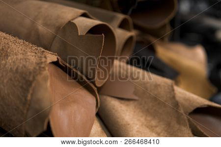 Different Pieces Of Leather In A Rolls. The Pieces Of The Colored Leathers. Rolls Of Natural Brown R