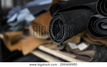 Different Pieces Of Leather In A Rolls. The Pieces Of The Colored Leathers. Rolls Of Natural Brown A
