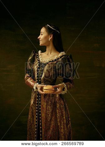 Girl In Medieval Beautiful Dress Or Costume Of The Countess At Dark Studio.