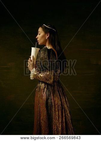 Girl In Medieval Beautiful Dress Or Costume Of The Countess At Dark Studio.