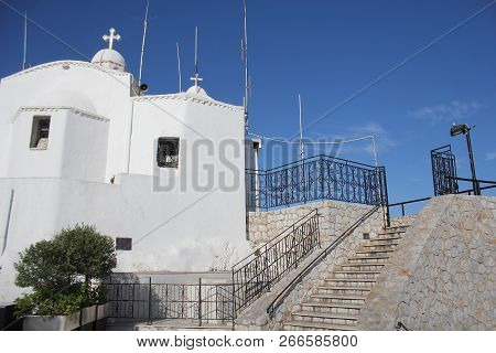 Aghios Georgios Church At Sunset On Lycabettus Hill In Athens Against A Blue Sky