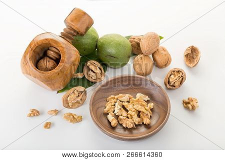 Walnuts And Nutctacker On White Background. Juglans Regia
