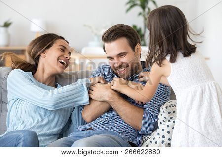 Family Have Fun Daughter And Mother Tickling Father