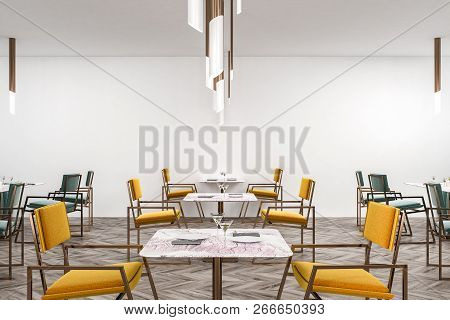 Interior Of Restaurant With White Walls, Wooden Floor, Yellow And Green Chairs Near Square Tables. 3