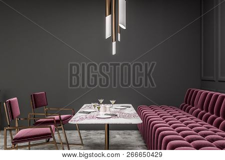 Side View Of Modern Restaurant With Gray Walls, Concrete Floor And Long Red Sofa With Red Chairs Nea
