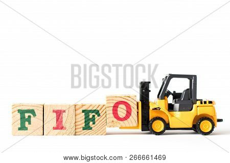 Toy Forklift Hold Letter Block  To Complete Word Fifo (abbreviation Of First In First Out) On White 