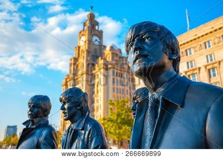 Liverpool, Uk - May 17 2018: Bronze Statue Of The  Beatles Stands At The Pier Head On The Side Of Ri