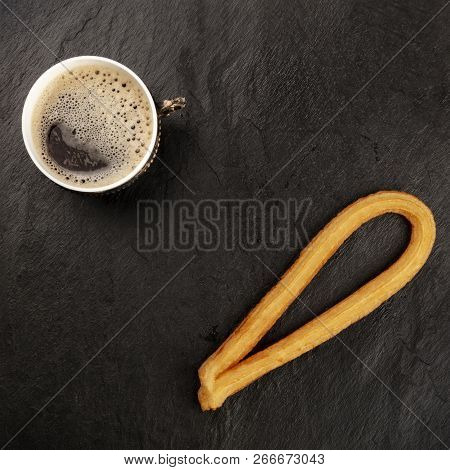 A Photo Of Black Coffee In A Vintage Cup And A Traditional Spanish Churro, A Typical Sunday Breakfas