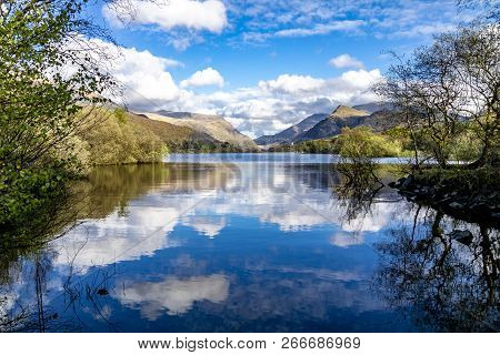 Reflections At Llyn Padarn With Dolbadarn Castle At Llanberis In Snowdonia National Park In Backgrou