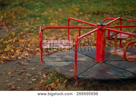 Baby Swing In The Fall In The Park In Wet Weather