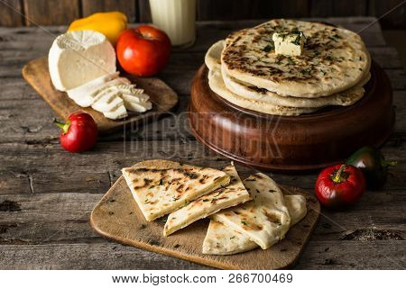 Pita Bread On Wooden Board With Feta Cheese And Tomatoes And Pepper. Still Life Of Food. Georgian Cu