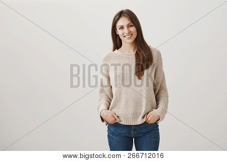Friendly Newbie Meets With New Teammates. Indoor Shot Of Shy Attractive Female In Casual Pullover St