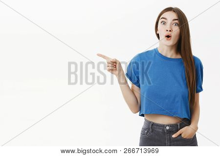 Amused And Thrilled Enthusiastic Attractive Brunette In Stylish Blue T-shirt Gasping Folding Lips Fr