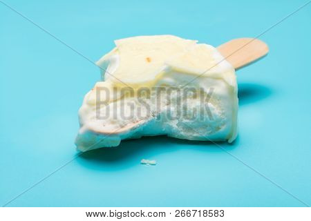 White Popsicle With Lots Of Bites On Blue Background