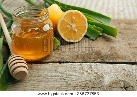 Home Spa Skincare Ingredients. Yellow Honey In Glass Jar And Lemon, Aloe Vera, Natural Beauty Produc