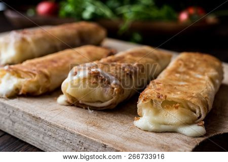 Turkish Pacanga Boregi With Pastirma And Cheddar (melted) Cheese. / Pastirmali Borek