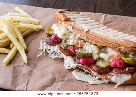 Turkish Toast Ayvalik Tostu / Sandwich With Sausage, Russian Salad, Melted Cheese And Pickle.