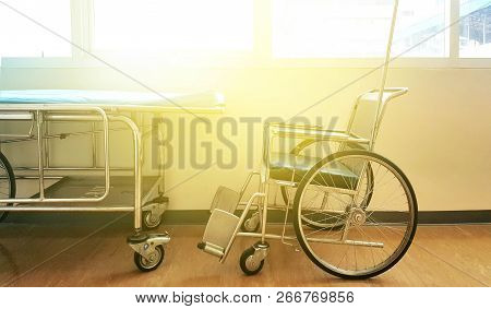 Stretcher Troller And Wheel Chair At The Hospital On The Windows Background .
