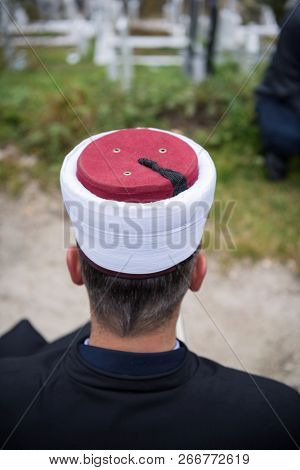 quran holy book reading by imam  on islamic funeral with white thumb stones graweyard background