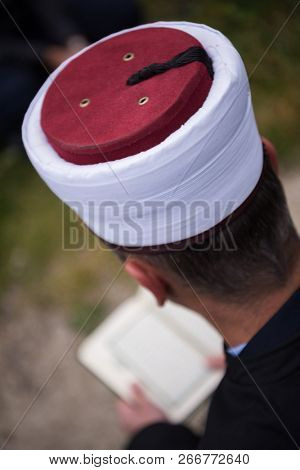 quran holy book reading by imam  on islamic funeral with white thumb stones graweyard background