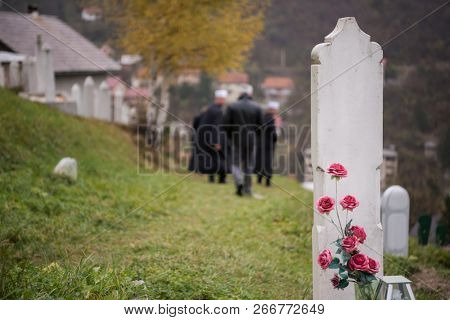 quran holy book reading by imam  on islamic funeral with white thumb stones graweyard background