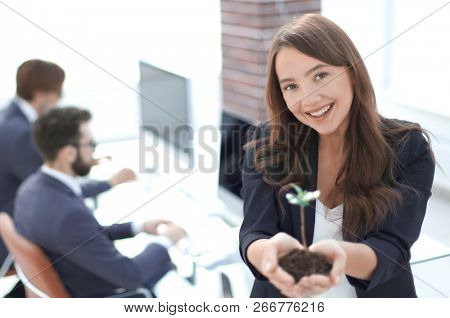 female environmentalist showing fresh sprout