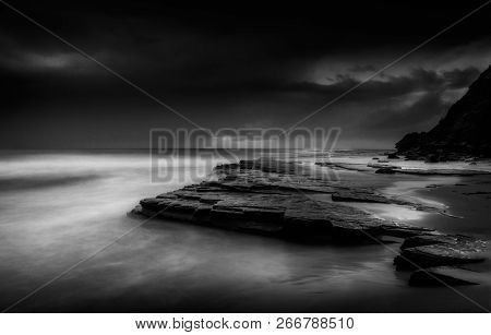 Storm Clouds Moving Out O Sea In He Dawn Hours. Long Exposure
