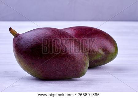Two Fresh Mango Fruits. Delicious Mango Fruits On Light Background Close Up. Nutrition Of Mango.
