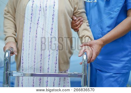 Asian Nurse Physiotherapist Doctor Care, Help And Support Senior Or Elderly Old Lady Woman Patient W