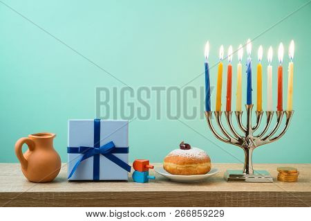 Jewish Holiday Hanukkah Background With Menorah, Sufganiyot, Gift Box And Spinning Top On Wooden Tab