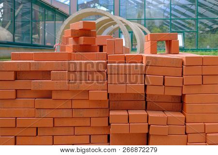 Stack Of Red Bricks For Build Construction.