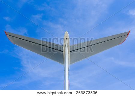 Tail Of A Passenger Airplane On Blue Sky Background With Clouds.