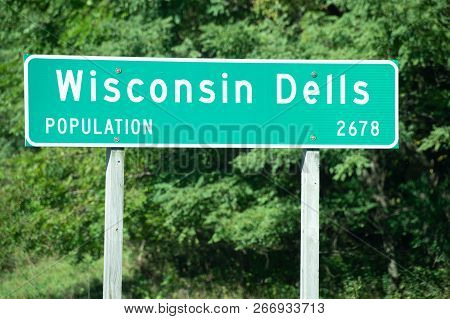 A Population Sign Wisconsin Dells, The Waterpark Capital Of The World.