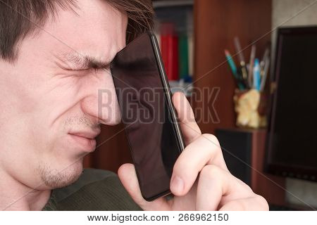 The Guy Tightly Squeezed His Eyes, Closed The Rum With A Black Smartphone