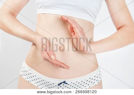 Concept Of Healthy Eating. Woman's Slim Stomack Isolated On White Background