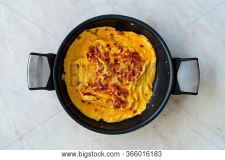 Omelette With Sweet Red Bell Capia Pepper In Pan For Breakfast Top View.