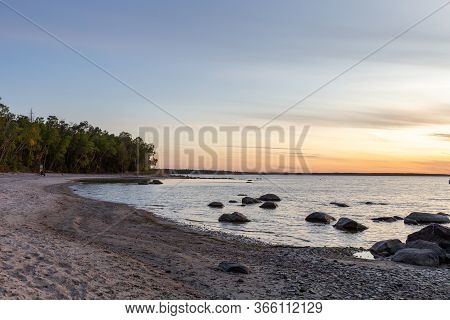 A Serene Beach Sunset On Lake Winnipeg