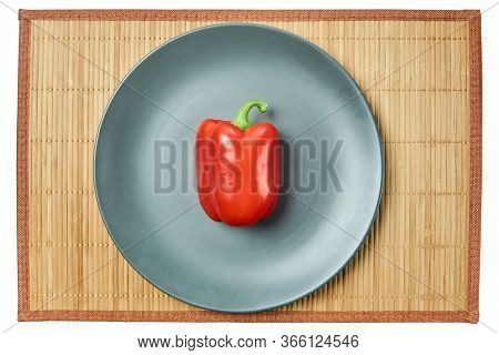 Color Still Life - Red Bell Pepper On A Gray Plate On A Cane Tablecloth