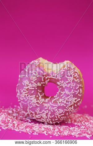 Donut Pink.baking And Sweets. Pink Bite Donut On A Pink Sweet Decor On A Fuchsia Background.sweet Do