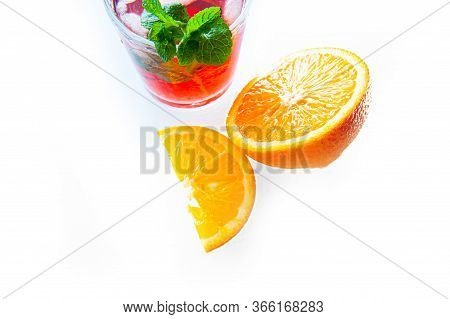 Fresh Red Lemonade Drink With Mint, Orange And Ice In Glass Jar On The Dark Background. Summer Cold 