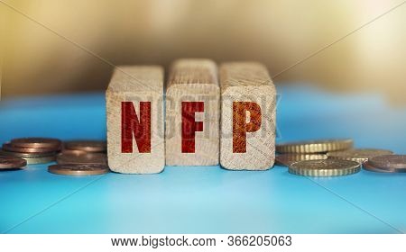 Wooden Blocks With The Word Nfp. Nonfarm Payrolls - Key Economic Indicator. Business Concept