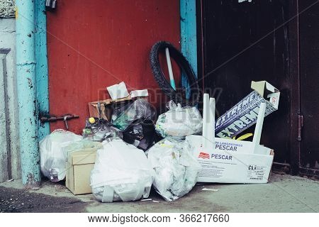 Garbage Piled Near Entrance To Urban Apartment Building. Trash Heap Blocked Garbage Chute. Bunch Of 