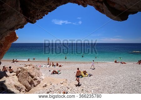 Konavle, Croatia - June 28, 2019: People Spend Vacation At Pasjaca Beach Below Cliffs In Konavle Reg