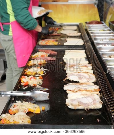 Sandwiches Stuffed With Meat And Vegetables In The Street Food Stall And The Cook During The Prepara