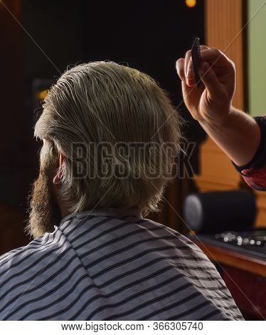 Guy With Long Dyed Blond Hair Close Up. Do Not Cut Your Own Hair. Barber Works On Hairstyle For Bear